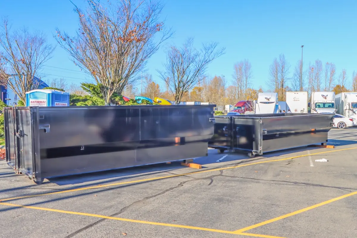 Professional dumpster rental service with roll-off container on residential driveway in Somerset